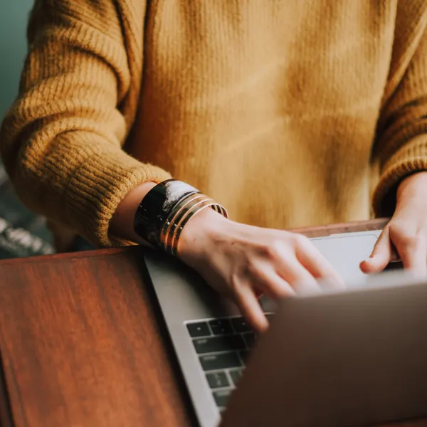 a woman types up another email update